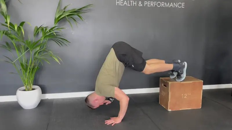 Elevated Pike Push-Up - do 3 sets of 10 elevated pike push-ups