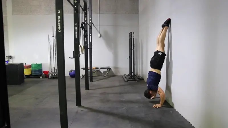 Wall Handstand Push-Up - do 3 sets of 10 wall handstand push-ups
