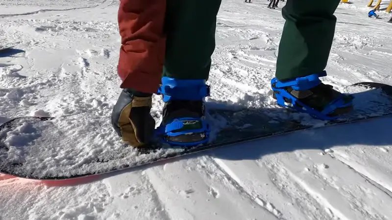 Strapping In - strap into your snowboard securely